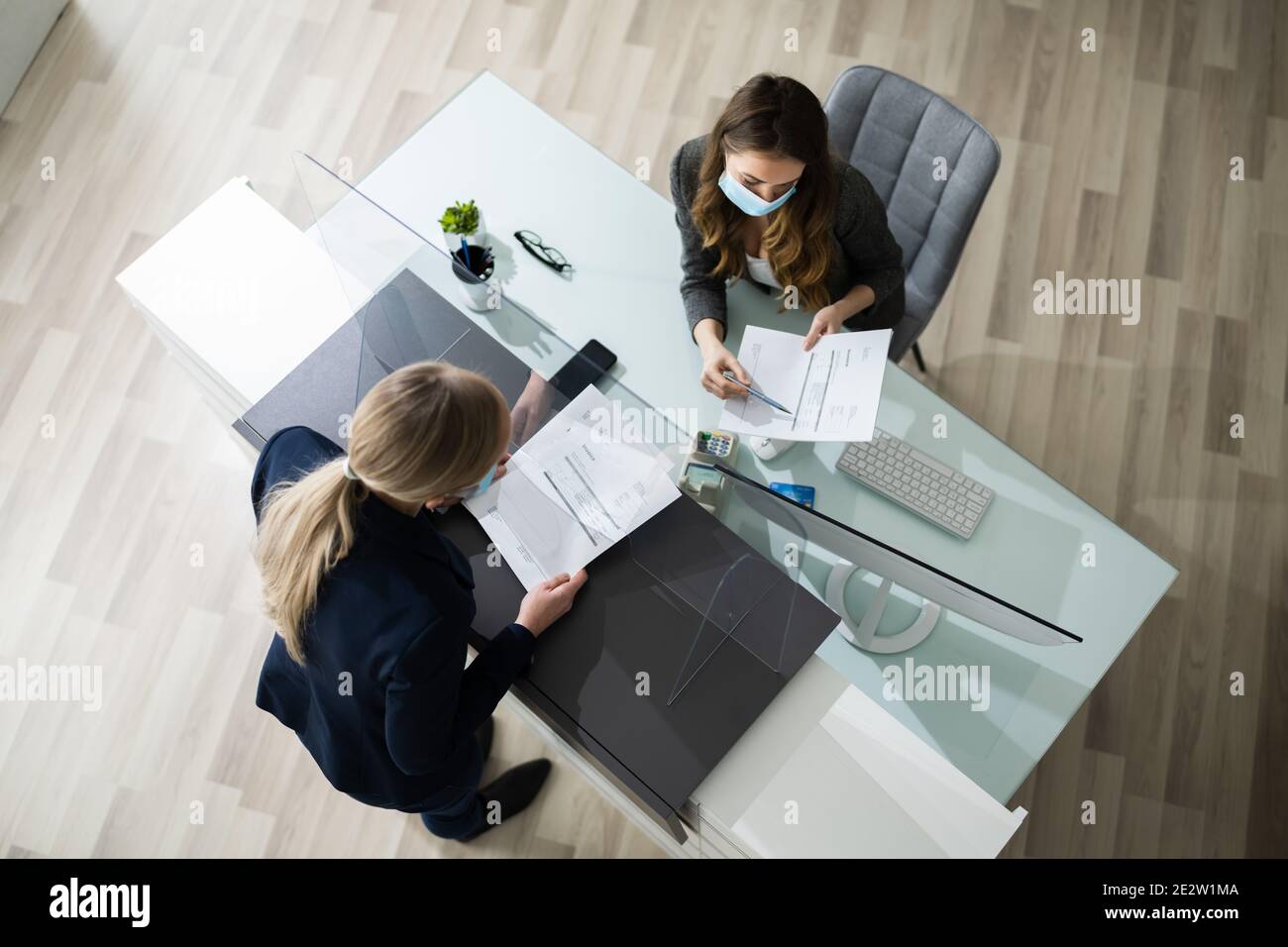 Hotel Reception Desk Protected By Medical Mask From Covid 19 Stock