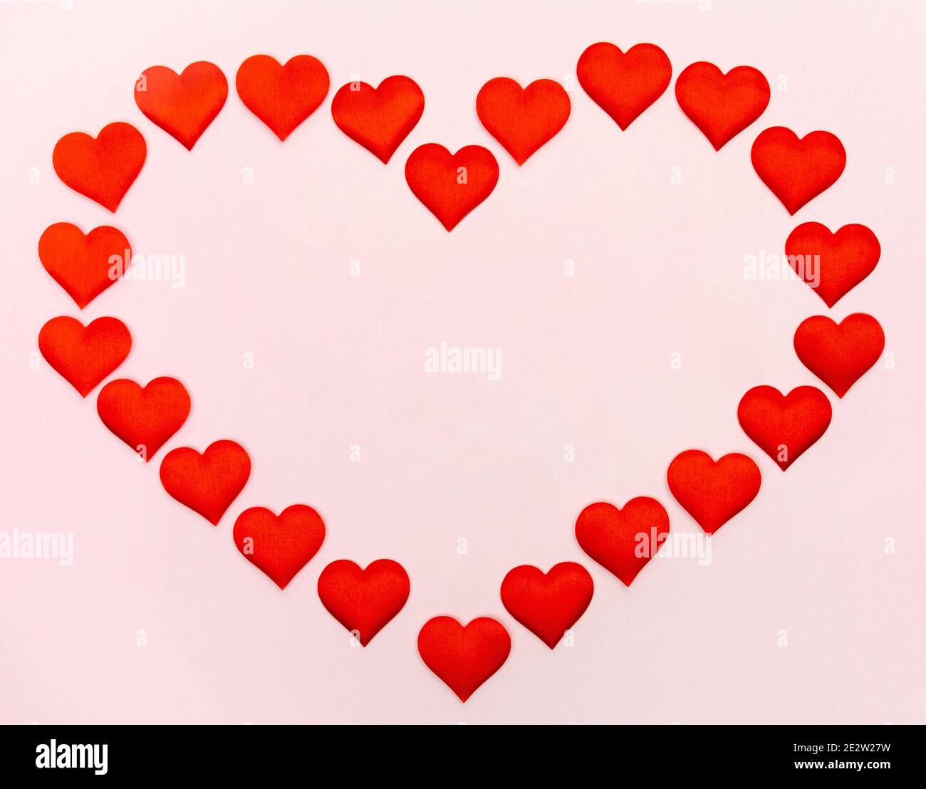 Big heart of small hearts with mock-up on a pink background. Concept of holidays and Valentines Day. Stock Photo