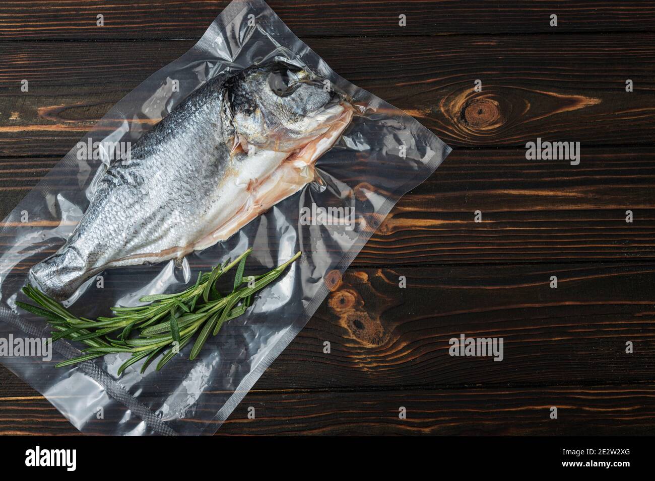 Vacuumpacked fish, dorado on a wooden board. Top view Stock Photo Alamy