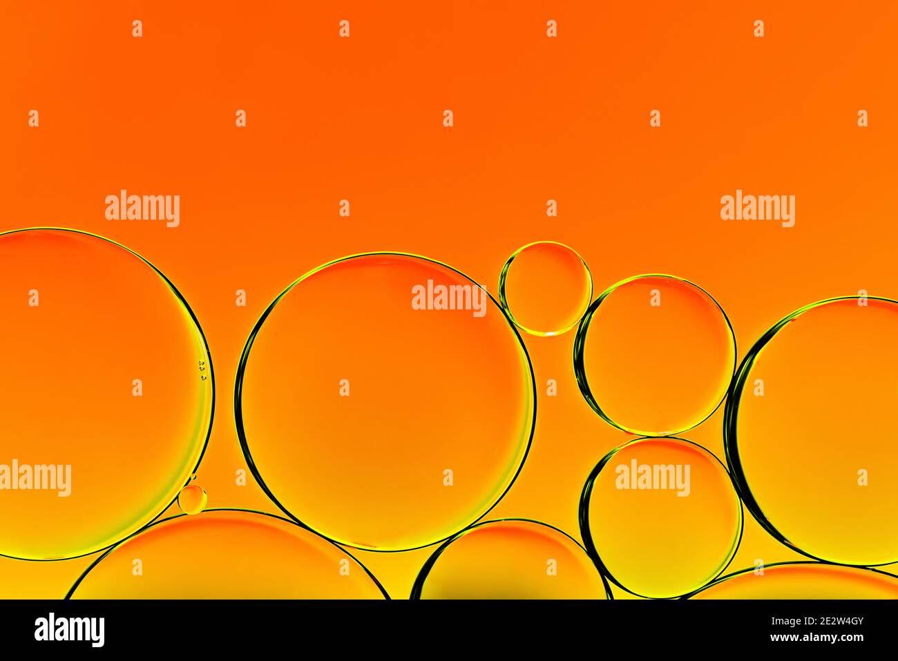 Orange oil drops. Bubbles of different sizes on orange abstract background Stock Photo