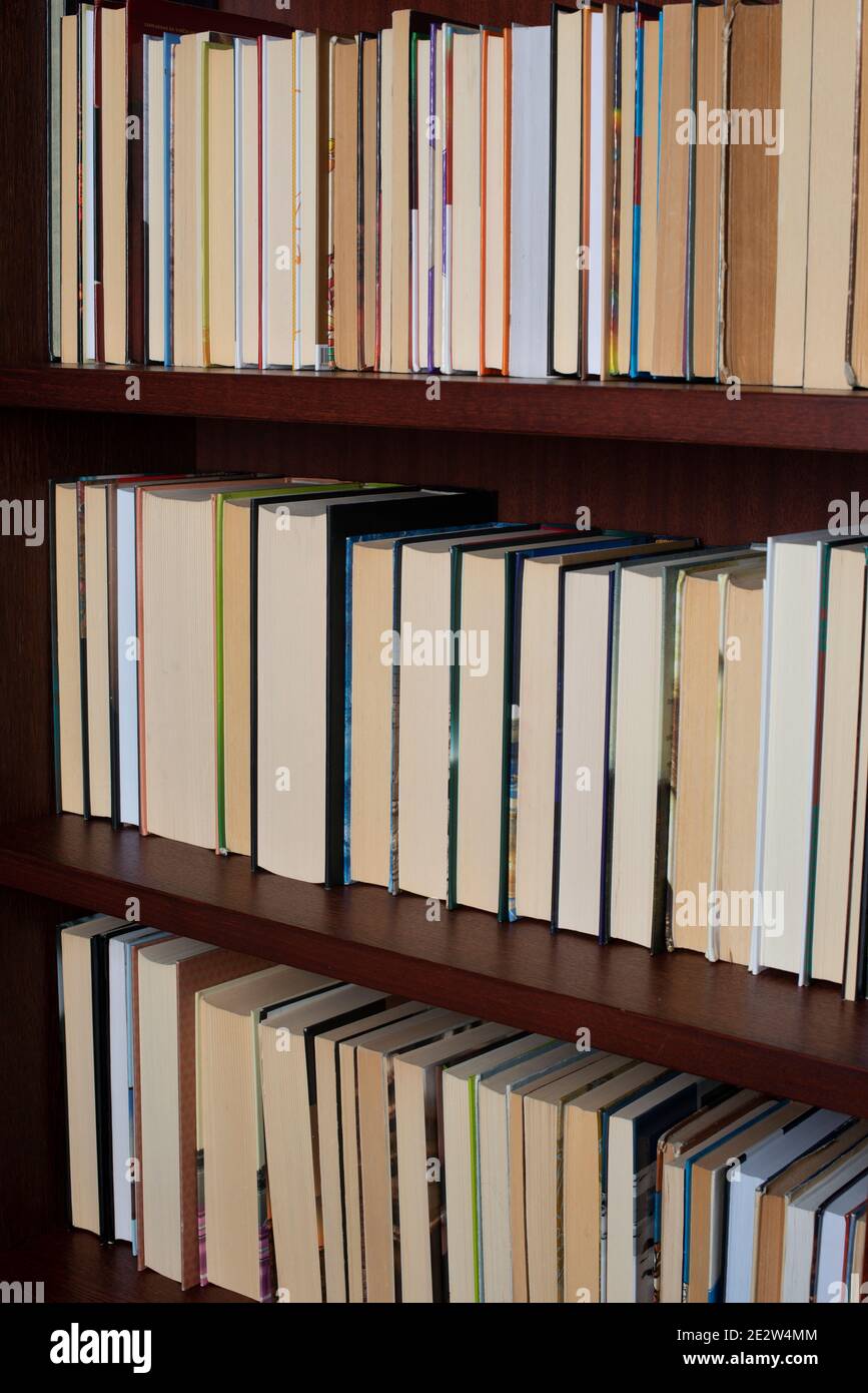 Bookshelf with books displayed backwards Stock Photo Alamy