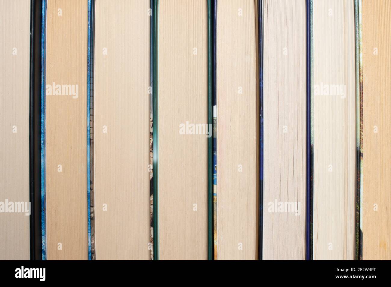 Bookshelf with books displayed backwards. Abstract background Stock Photo Alamy