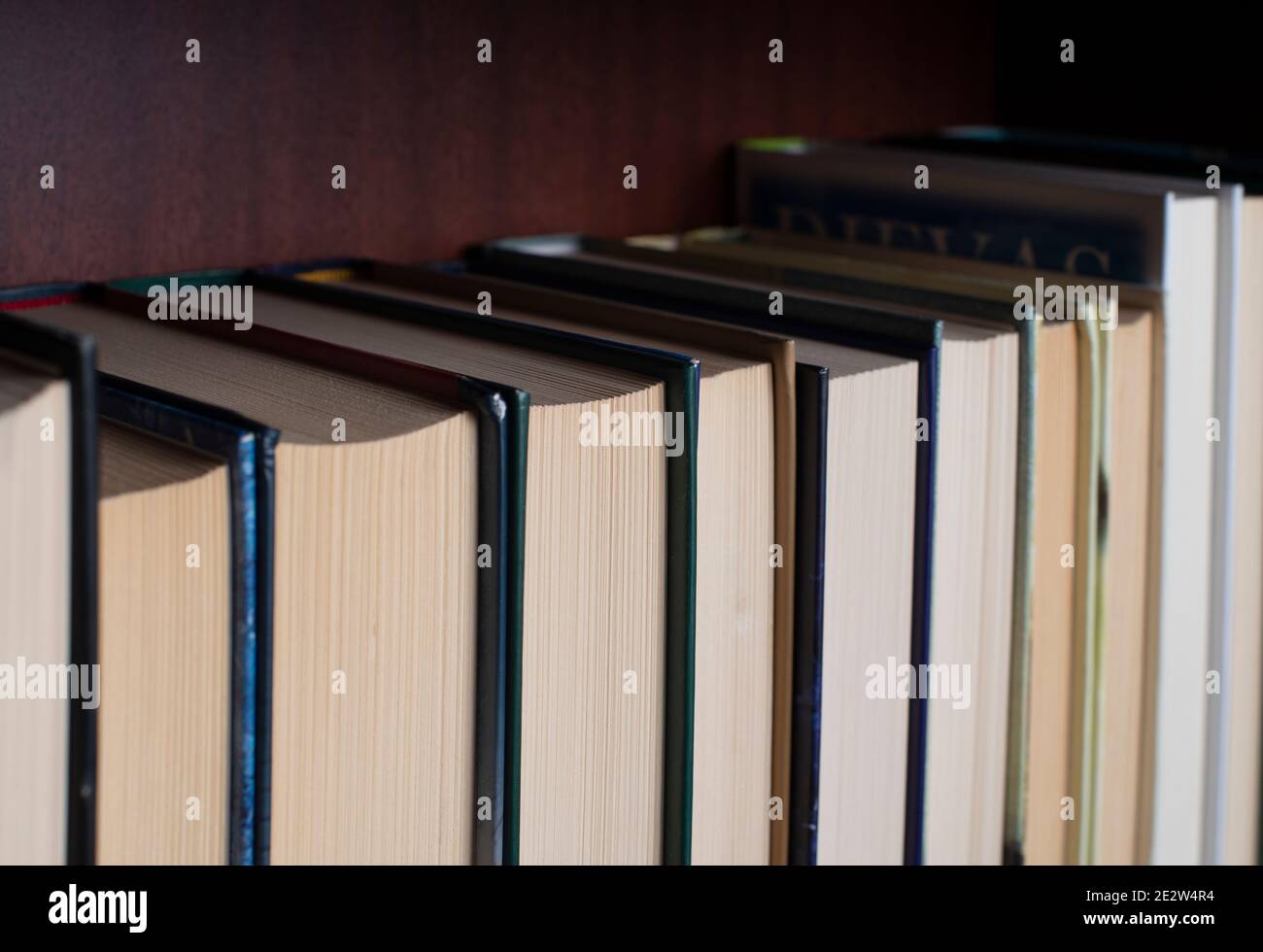 Bookshelf with books displayed backwards Stock Photo Alamy