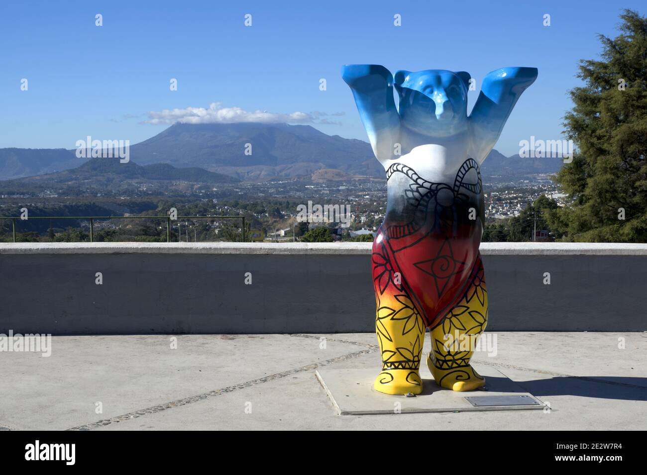 Guatemala City, Central America: Berlin square in Guatemala City with bear figure painted in Germany's national colors with vulcano in background Stock Photo