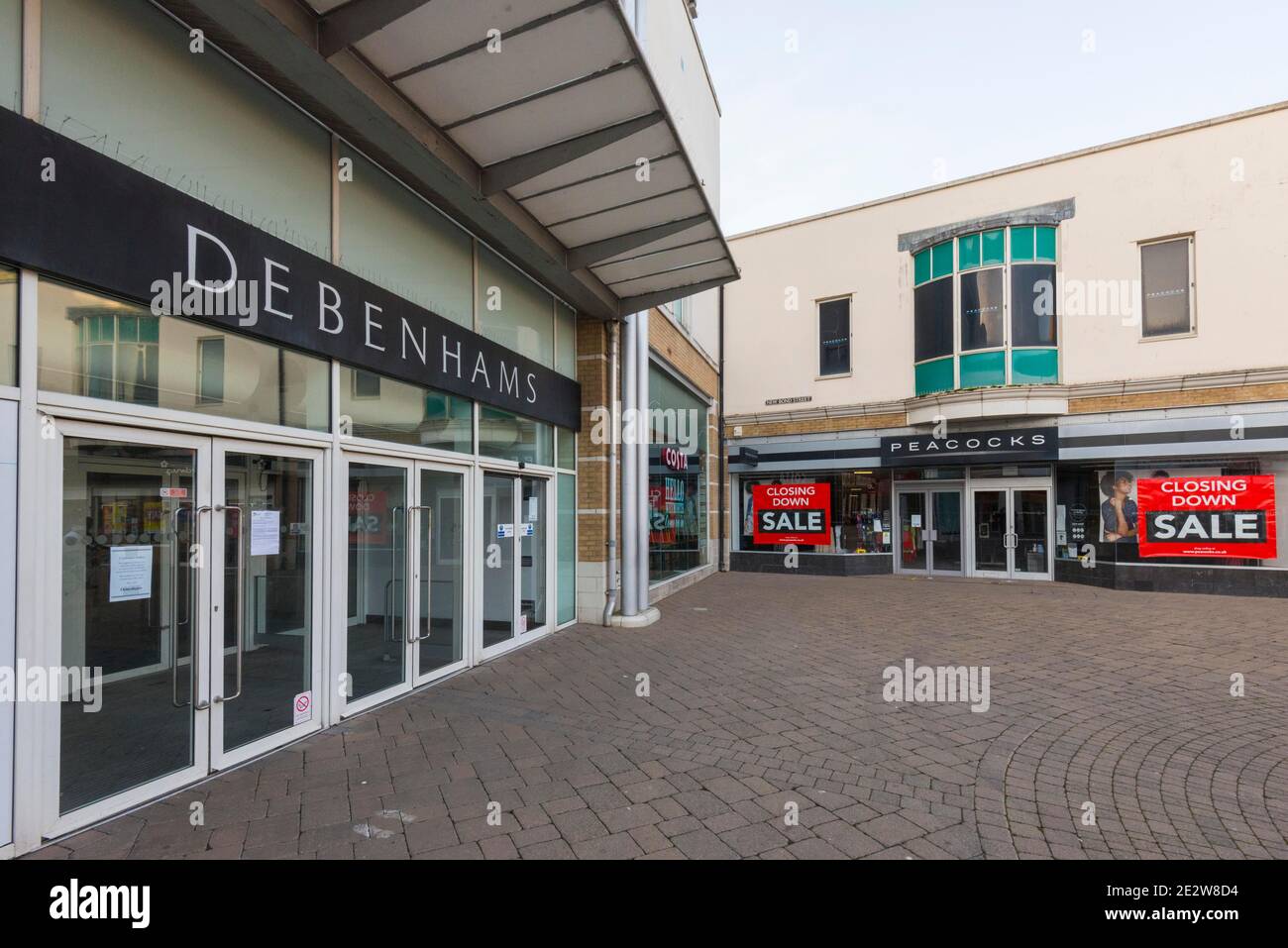 Weymouth, Dorset, UK.  15th January 2021.  General view of the Debenhams department store at Weymouth in Dorset which will not be re-opening when lockdown ends.  Next to it is a Peacocks shop which has closing down sale signs in the window. Picture Credit: Graham Hunt/Alamy Live News Stock Photo