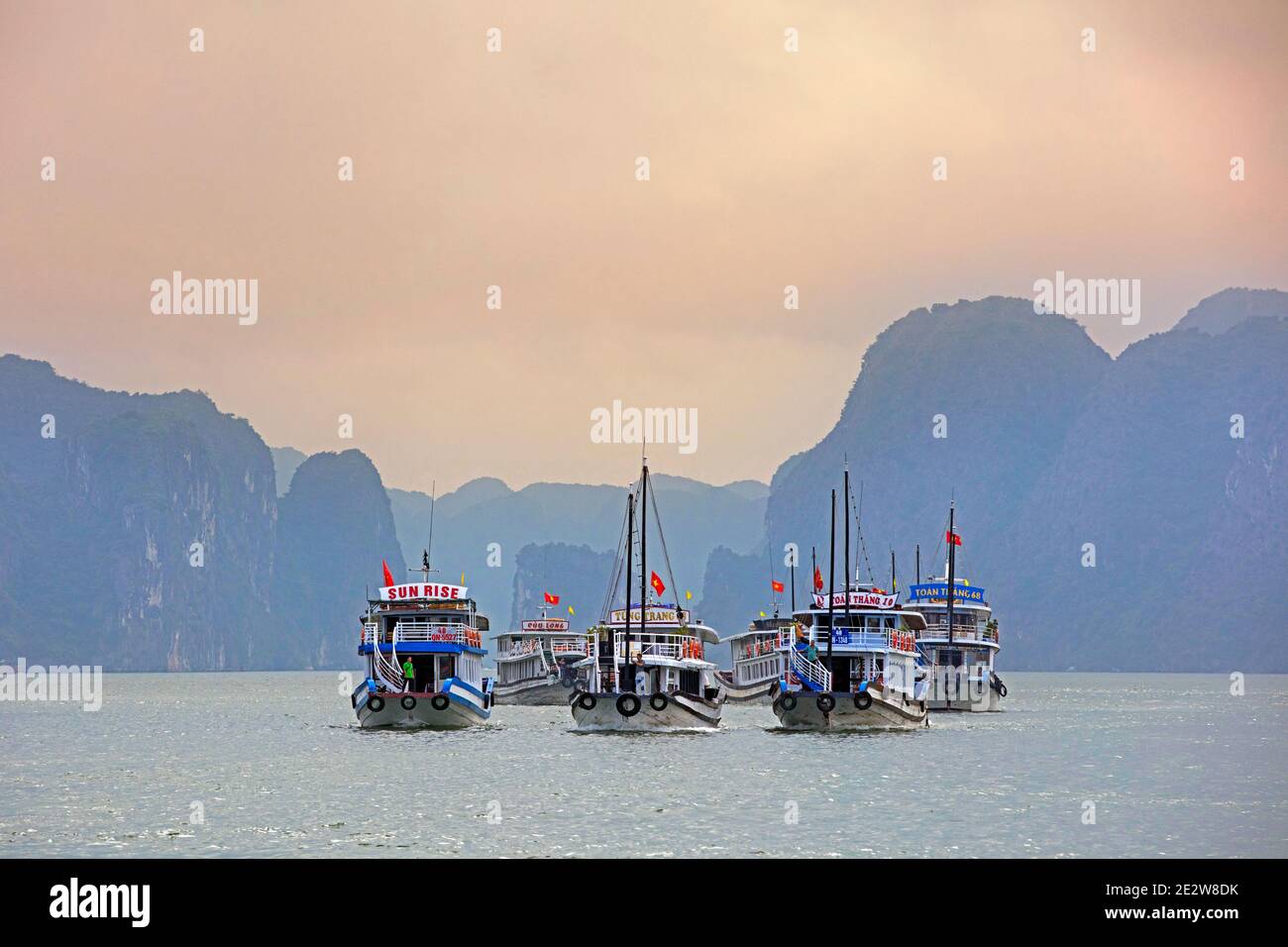 Tourist boats and limestone monolithic islands in Ha Long Bay / Halong Bay / Vinh Ha Long, Quang Ninh Province, Vietnam Stock Photo