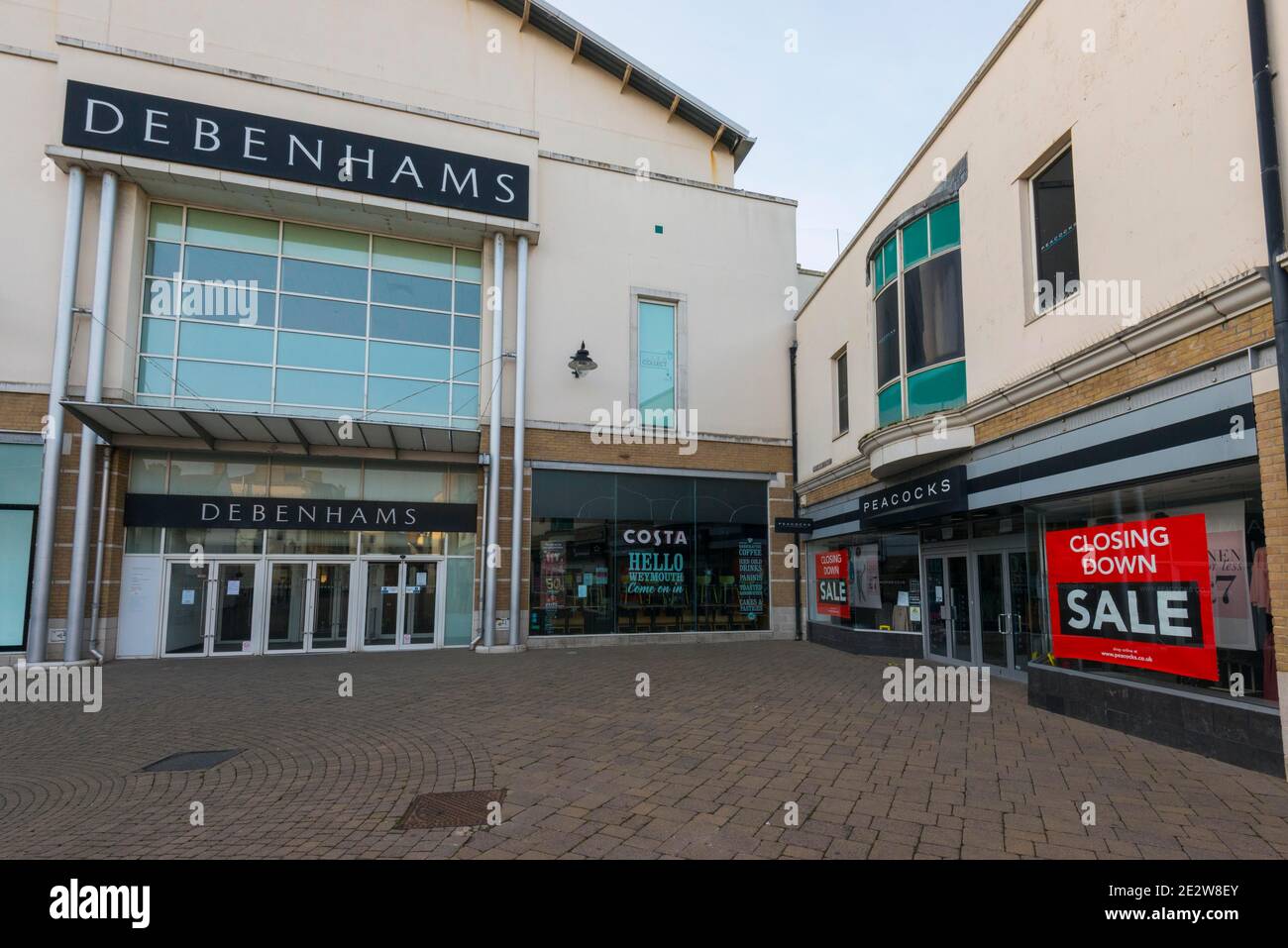 Weymouth, Dorset, UK.  15th January 2021.  General view of the Debenhams department store at Weymouth in Dorset which will not be re-opening when lockdown ends.  Next to it is a Peacocks shop which has closing down sale signs in the window. Picture Credit: Graham Hunt/Alamy Live News Stock Photo