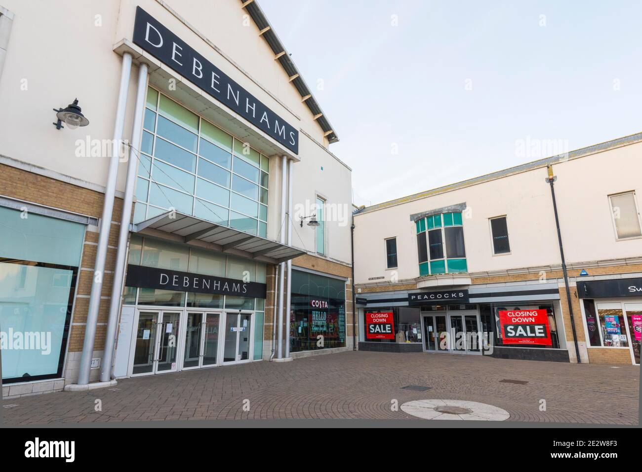 Weymouth, Dorset, UK.  15th January 2021.  General view of the Debenhams department store at Weymouth in Dorset which will not be re-opening when lockdown ends.  Next to it is a Peacocks shop which has closing down sale signs in the window. Picture Credit: Graham Hunt/Alamy Live News Stock Photo