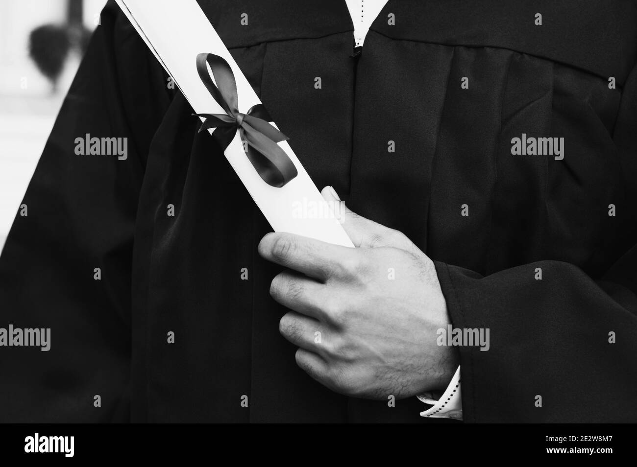 Black and white photo of student holding diploma on graduation day ...