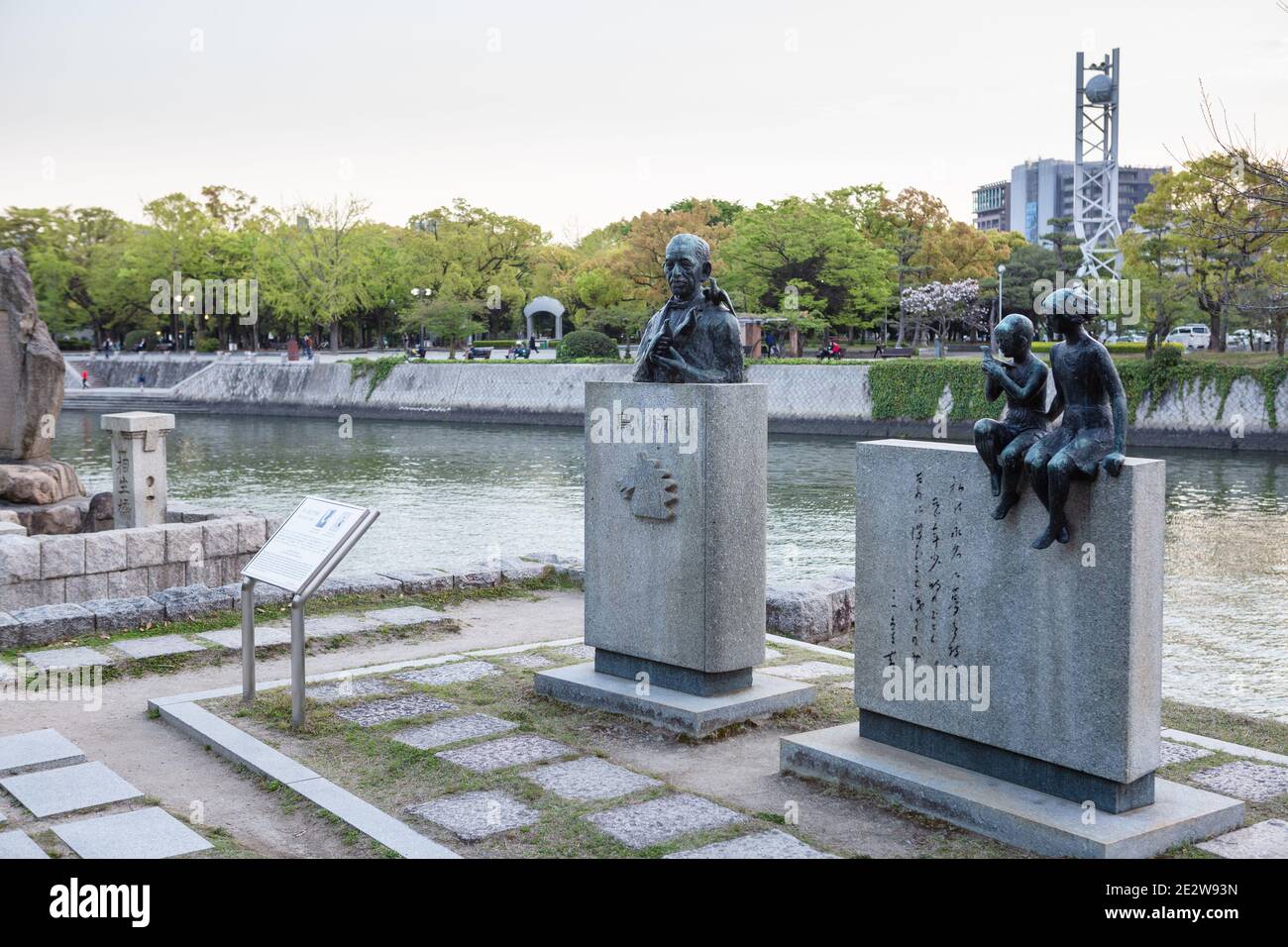 Suzuki Miekichi Literary Monument in the late afternoon/early evening, with the river and Peace Clock Tower behind, Hiroshima, Japan Stock Photo