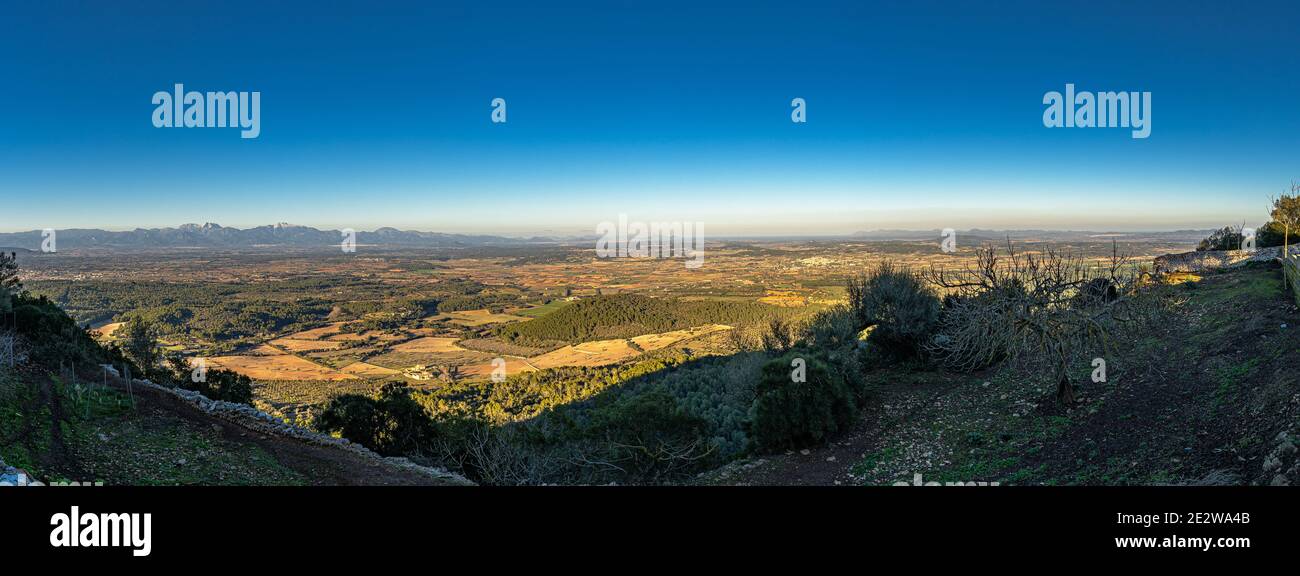 panoramic view from the sanctuary or Randa, in Mallorca, with the snow-capped mountains in the background. Stock Photo