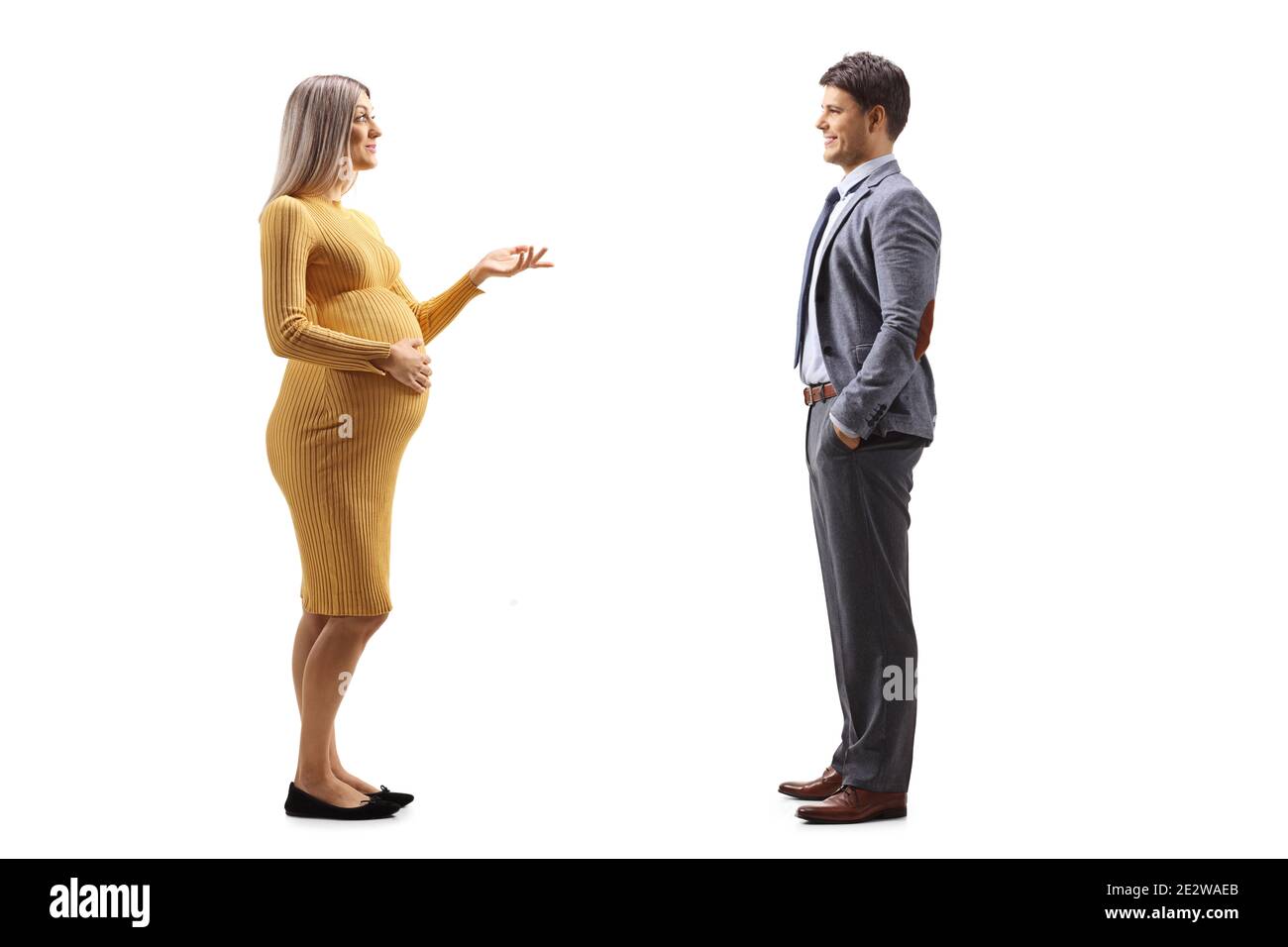 Full length profile shot of a pregnant woman talking to her husband isolated on white background Stock Photo