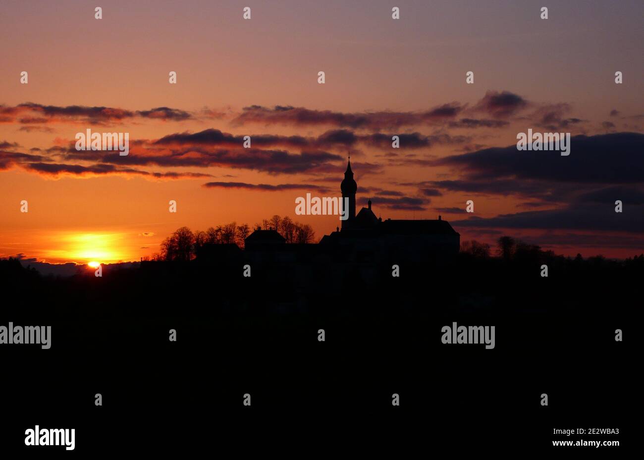 Andechs Abbey (Kloster Andechs) at sunset as a silhouett against the evening sky Stock Photo