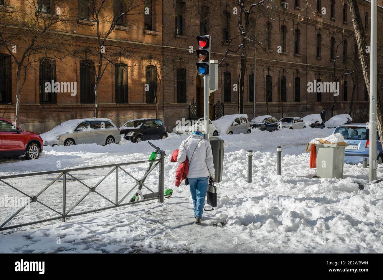 Madrid, Spain. 10 th January 2021. View of walkers in San Bernardo street, Chamberi quarter, after Filomena snow storm. Credit: Enrique Davó. Stock Photo