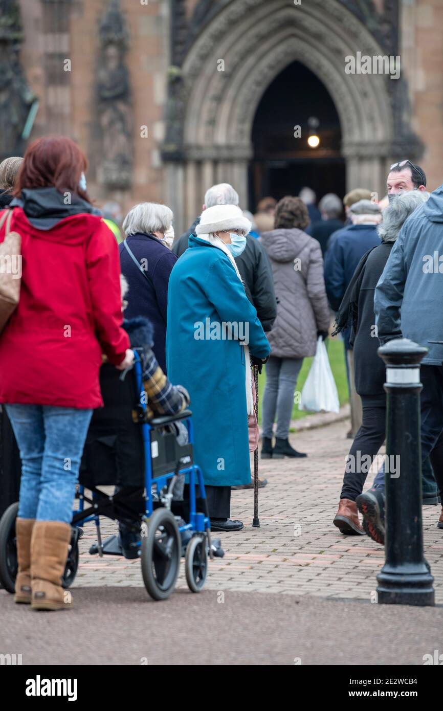 15 JANUARY 2021.   LICHFIELD, STAFFORDSHIRE. UK Lichfield Cathedral opens its doors to be a Coronavirus vaccination venue. The over 80's are invited to attend for the first of 2 vaccinations against Covid-19 and queue in near zero degree celsius temperatures. Stock Photo