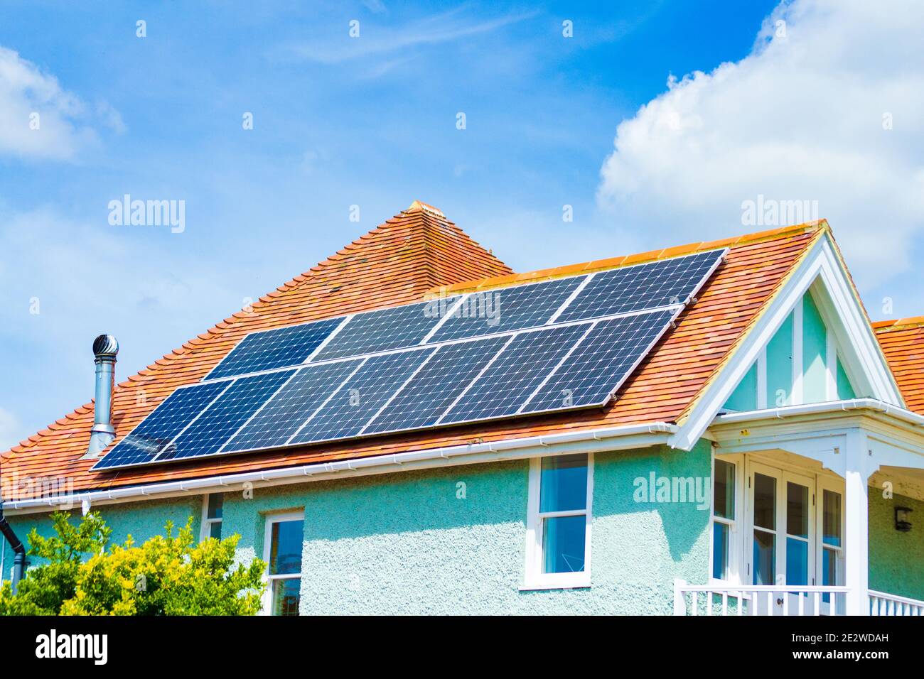 Solar Panels on roof of English home against nice summer blue skies