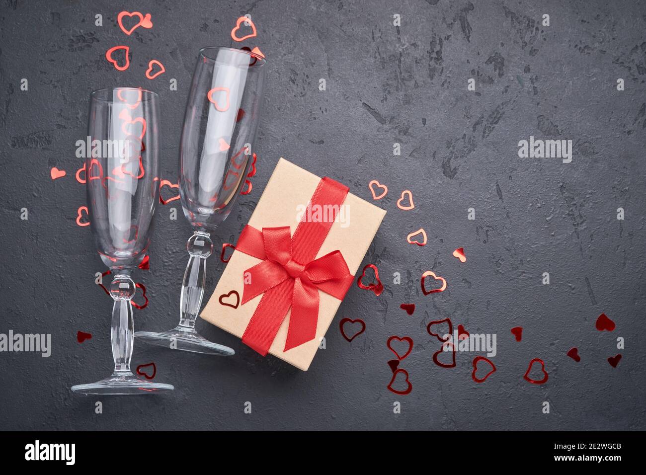 Valentine's day greeting card with champagne glasses and gift box with ...