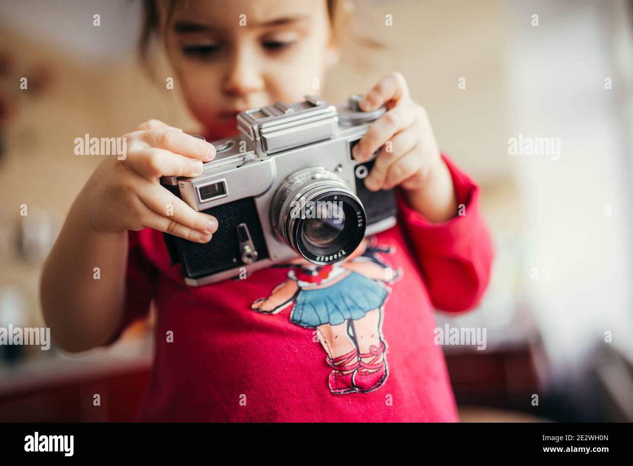 Little girl holding and setting analog camera Stock Photo Alamy
