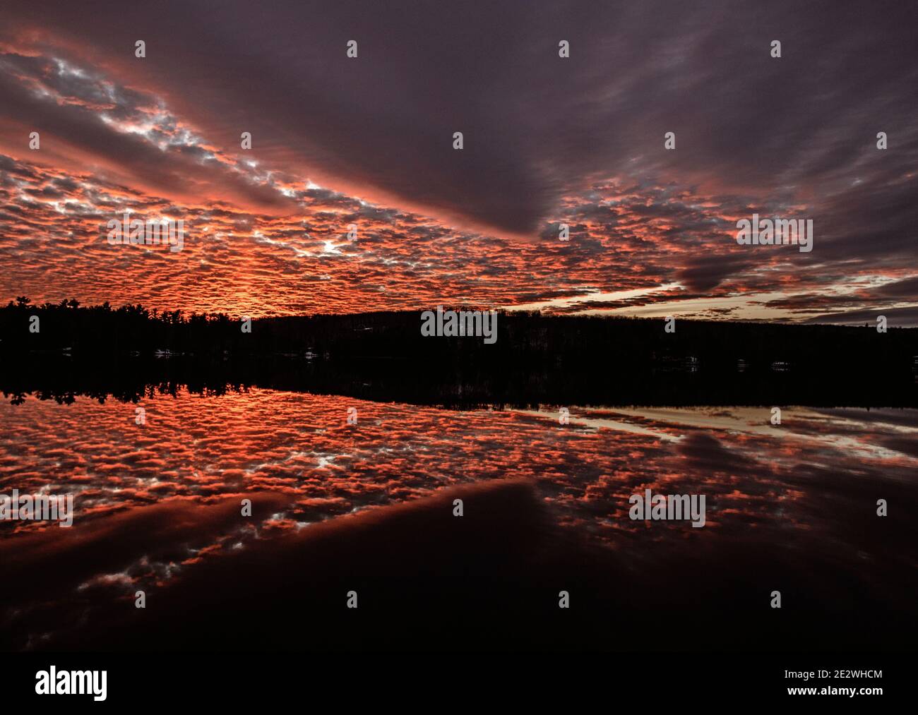 beautiful red sunset reflected in Round Pond, Livermore, Maine Stock