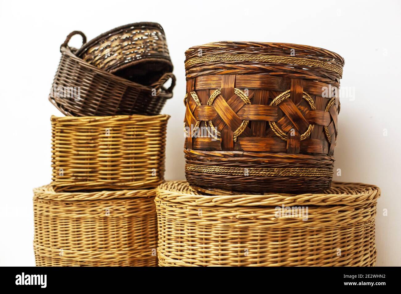 Six natural wicker straw baskets different sizes, shapes and patterns
