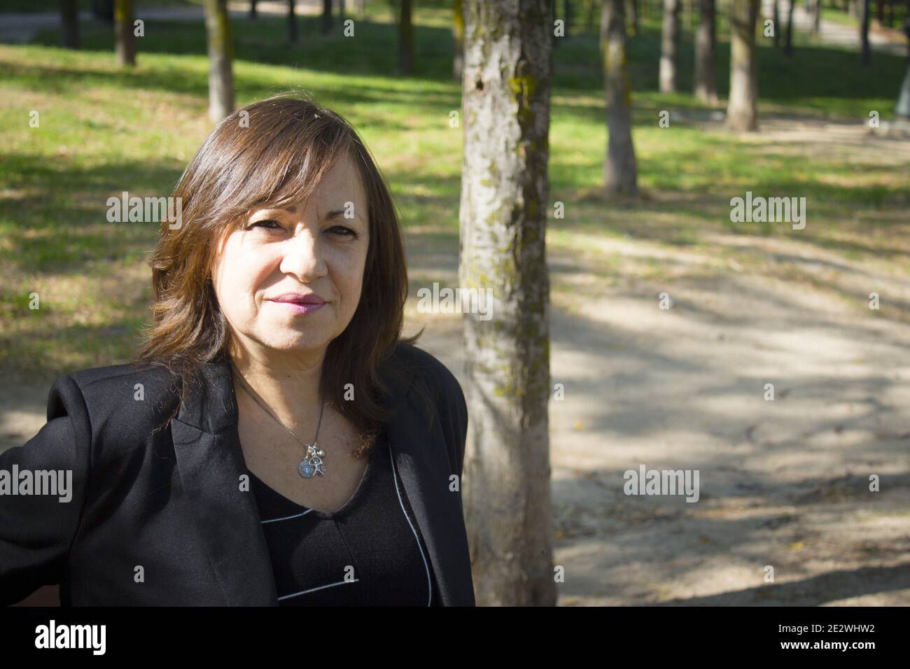 Mature woman in positive attitude sitting and standing Stock Photo - Alamy