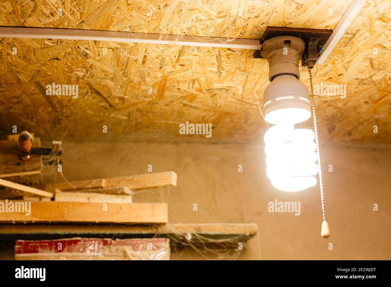 old incandescent light bulb on a wooden ceiling Stock Photo Alamy
