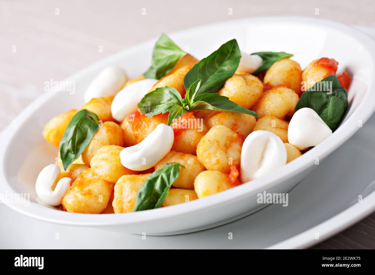 Homemade gnocchi with tomato sauce basil and mozzarella Stock Photo Alamy