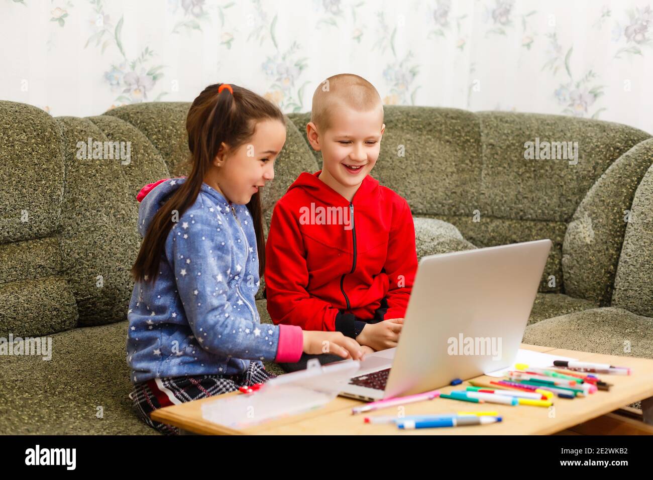 Distance learning online education. school boy and girl studying at ...