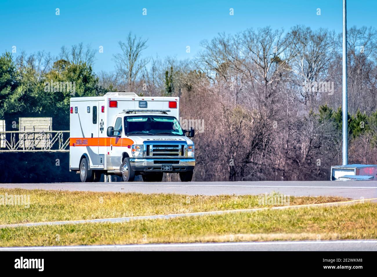 Horizontal shot of a generic ambulance on a roadway. Stock Photo