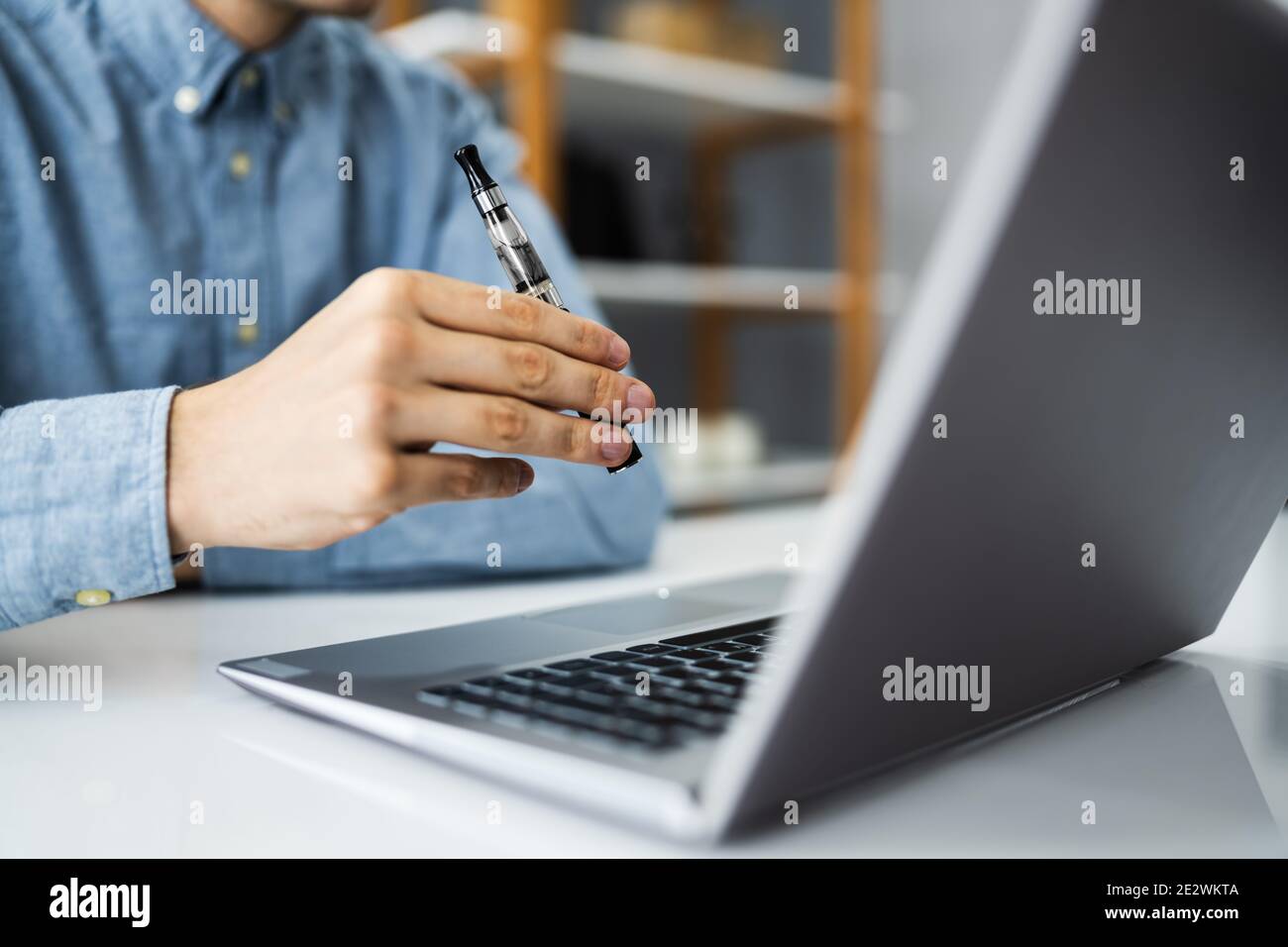 Virtual Smoking Break Using Electronic Cigarettes And Video Conference Stock Photo
