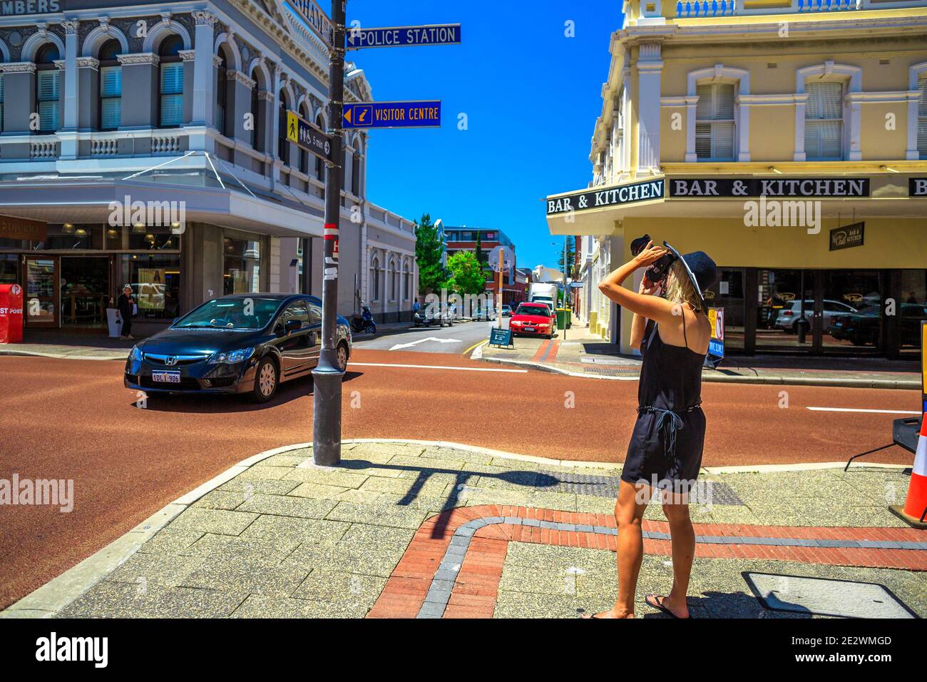 Fremantle, Western Australia, Australia - Jan 2, 2018: woman tourist photographs historic buildings in central urban street port city of Perth Stock Photo