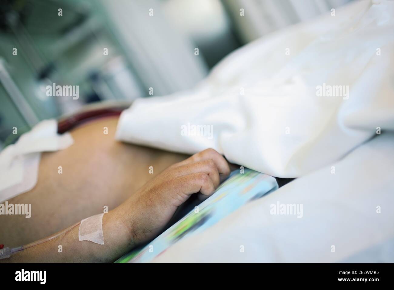 Patient in serious condition in the intensive therapy department. Stock Photo