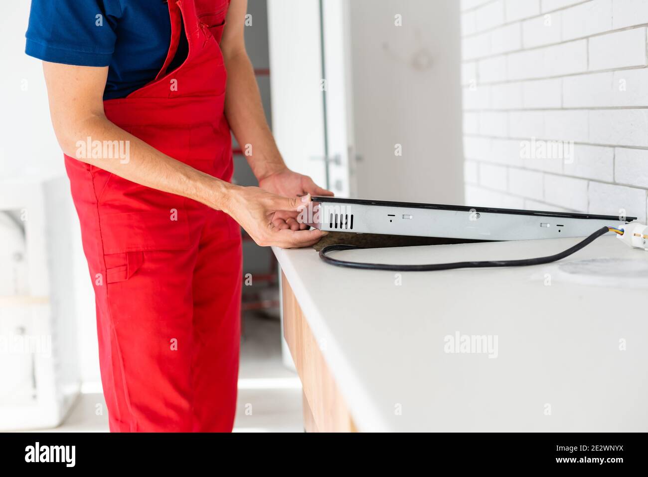 Installation of induction stove or cooktop by a master Stock Photo Alamy
