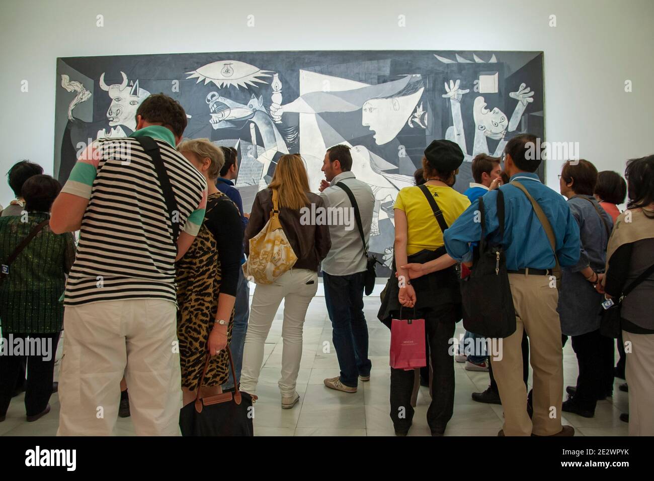 A crowd gathers to view Guernica by Pablo Picasso in Museo Reina Sofia Madrid Spain Stock Photo
