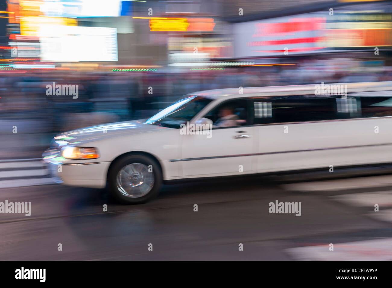 Limo moving quickly through Times Square New York Stock Photo Alamy