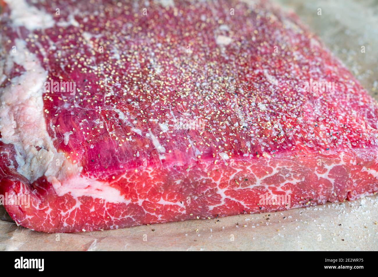 Raw Flank Steak on Butcher Paper: An uncooked London broil fillet on