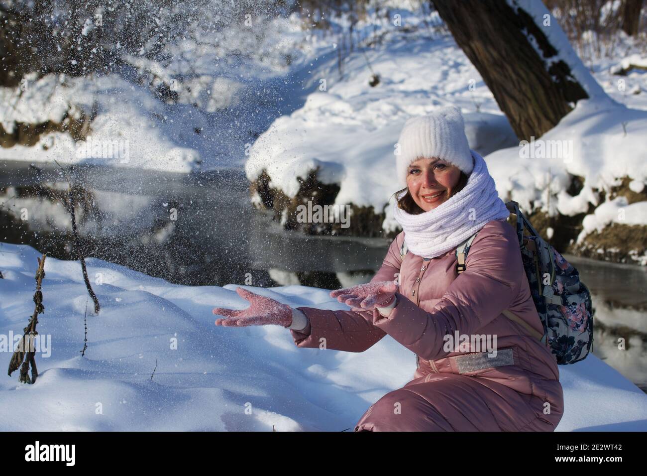 Woman in winter clothes on a walk in the park. There is a lot of