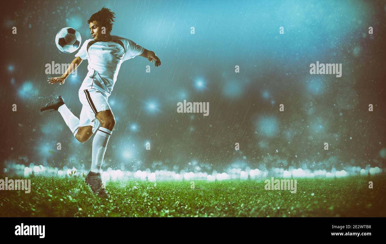 Soccer action scene with a footballer in white uniform performing a heel ball stop Stock Photo