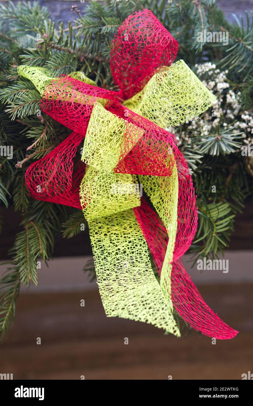 red and lime green fabric bow on a Christmas wreath Stock Photo