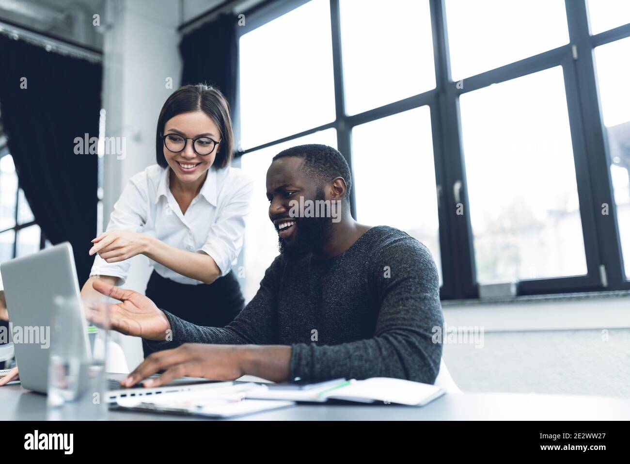 Young and heterogeneous co-workers working with pc in the office Stock Photo