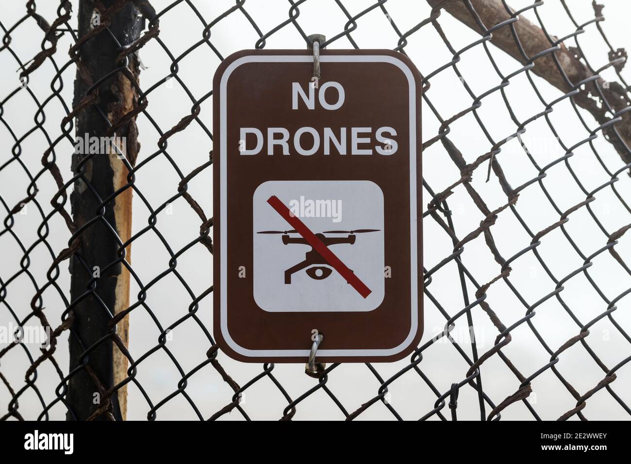 No drones warning sign on old rusty fence. Stock Photo