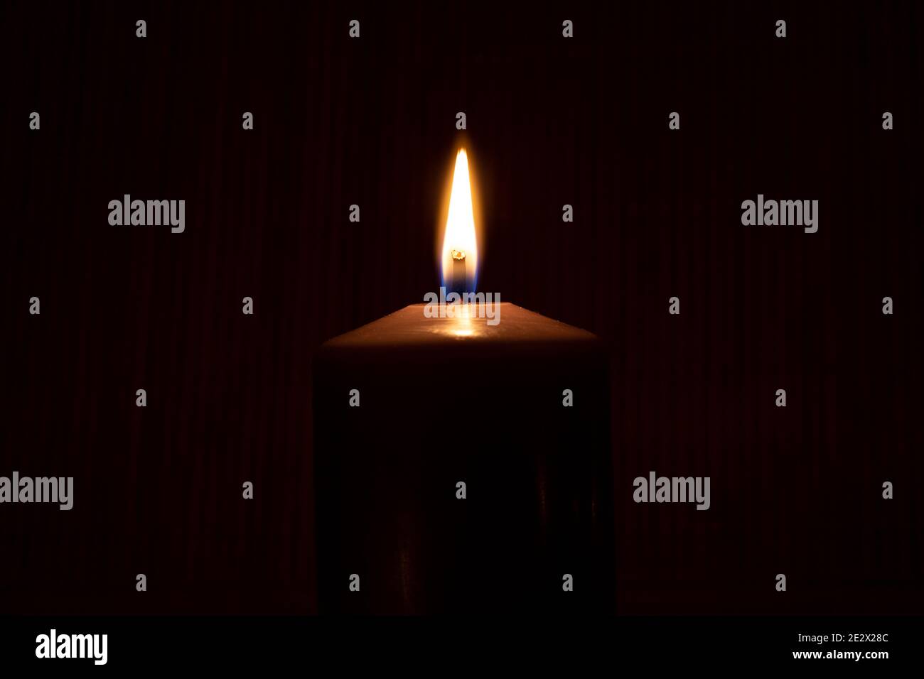 Close-Up Of Illuminated Candle Against Black Background Stock Photo