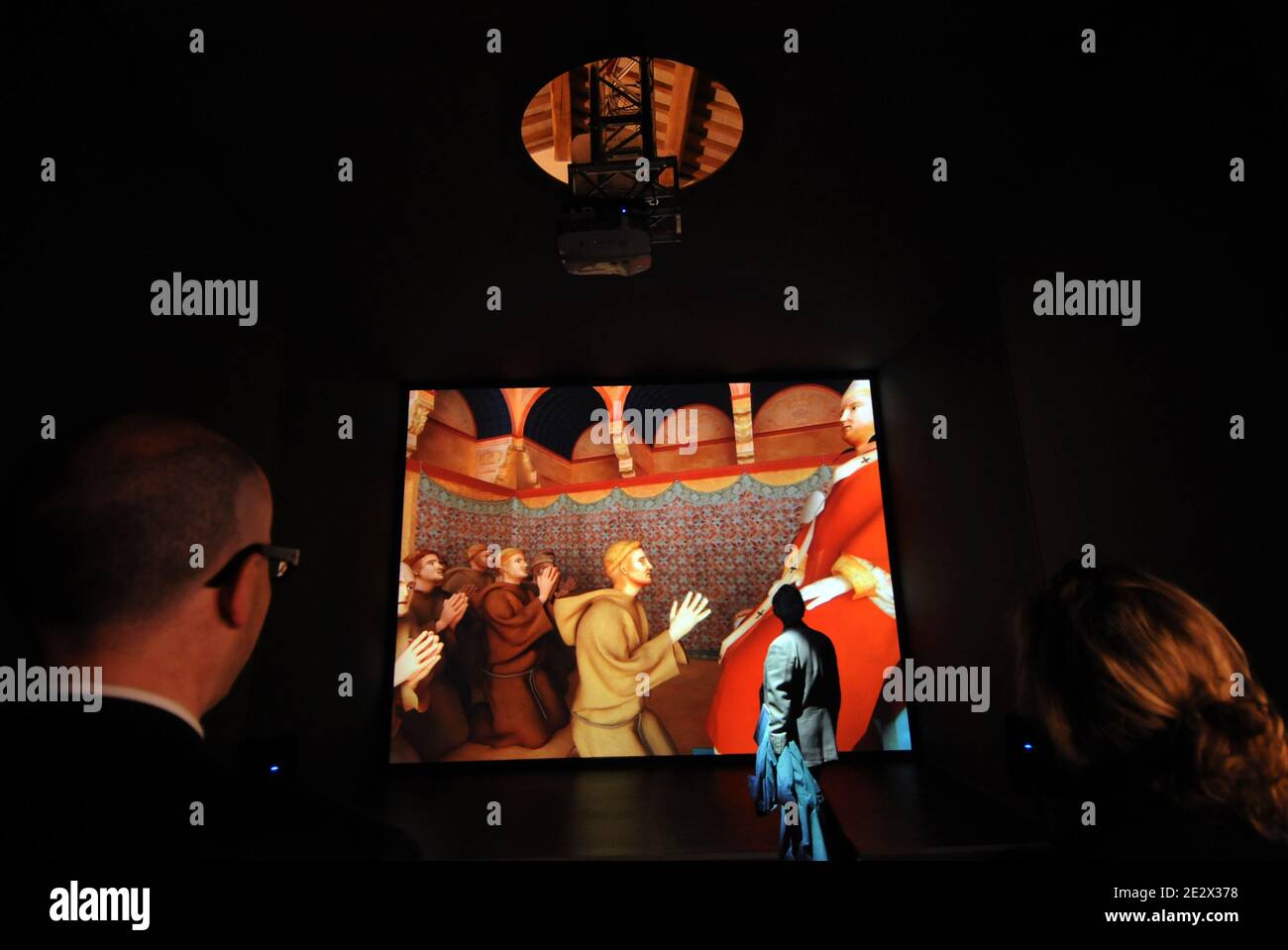 A section of the exhibition allows visitors to 'enter' the fresco.The poster image of the iniziative, showing Pope Innocent III officialy approving the Rule of St Francis, has been transformed into a full-scale three-dimensional installation.The life-sized scene depicts animated characters, including the pontiff welcoming the saint and his followers, which react to the movements of visitors 'entering' the image. 'The Colours of Giotto' : open restoration site and virtual reconstruction in the Basilica of Saint Francis in Assisi, Italy on april 10, 2010. On the 800th anniversary of the foundati Stock Photo