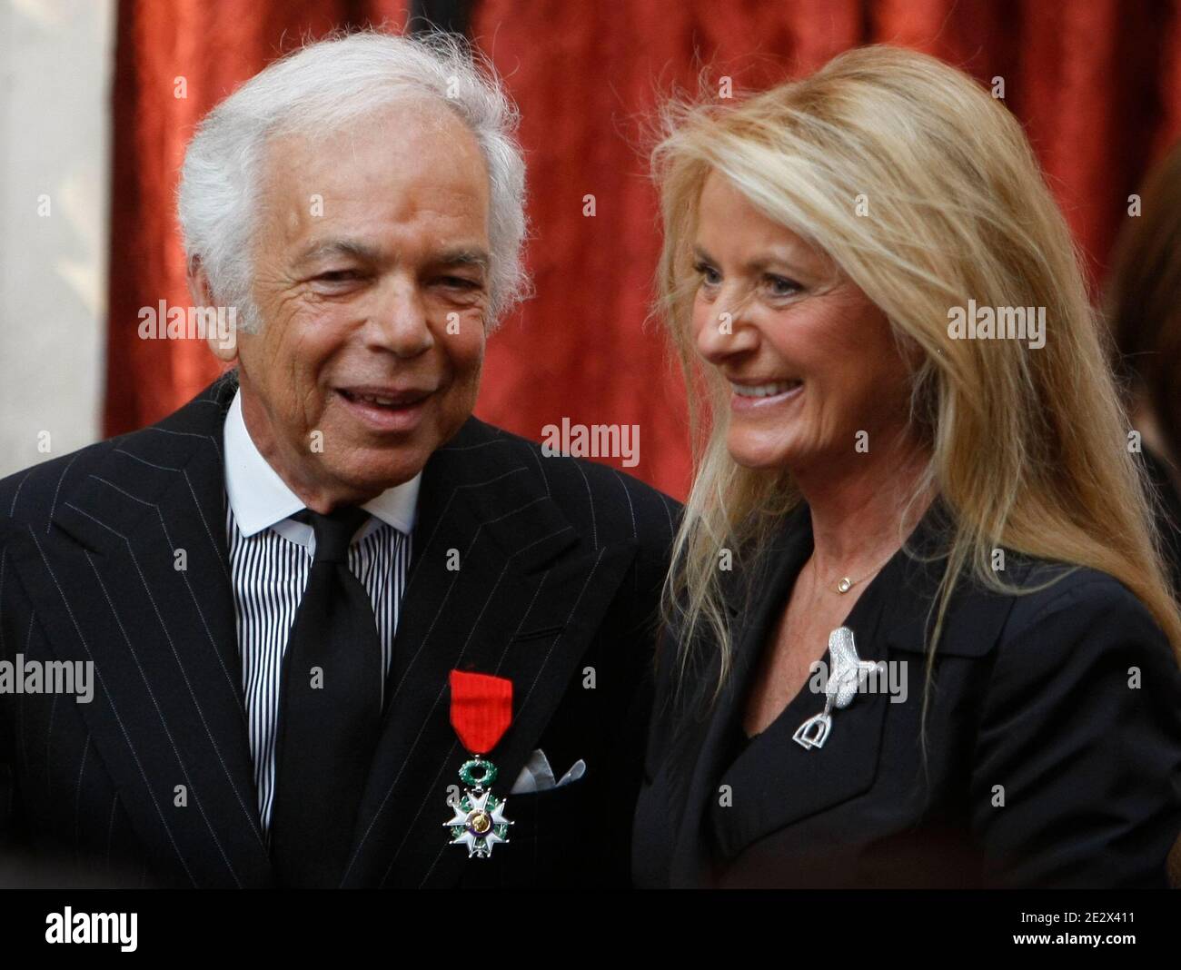U.S. fashion designer Ralph Lauren, left, poses with his wife Ricky after  being awarded Chevalier of the Legion of Honor, one of France's most  prestigious distinctions, by French President Nicolas Sarkozy, unseen,