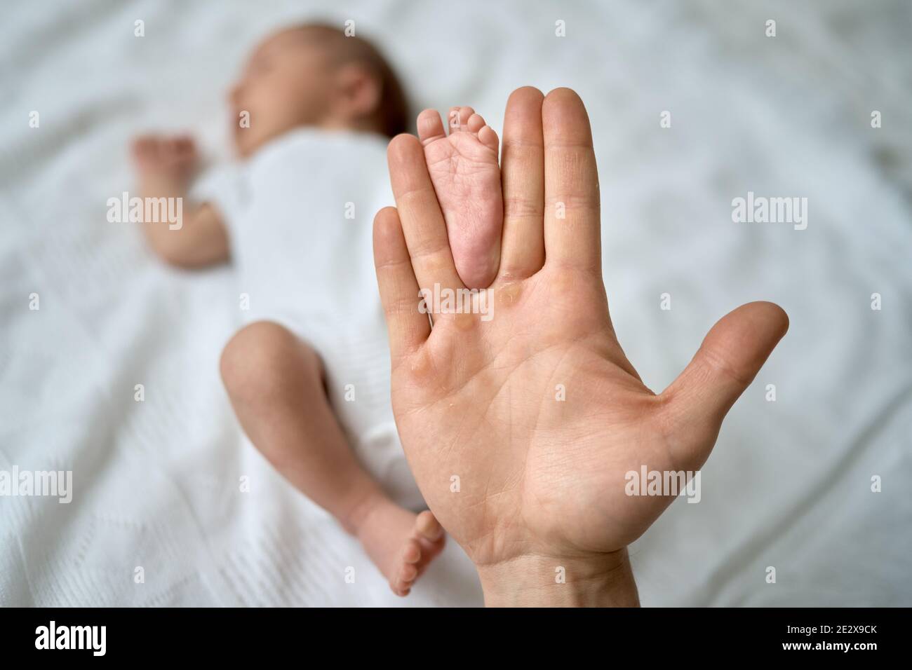 Baby's feet in the father's hands, the foot of a newborn baby, a little