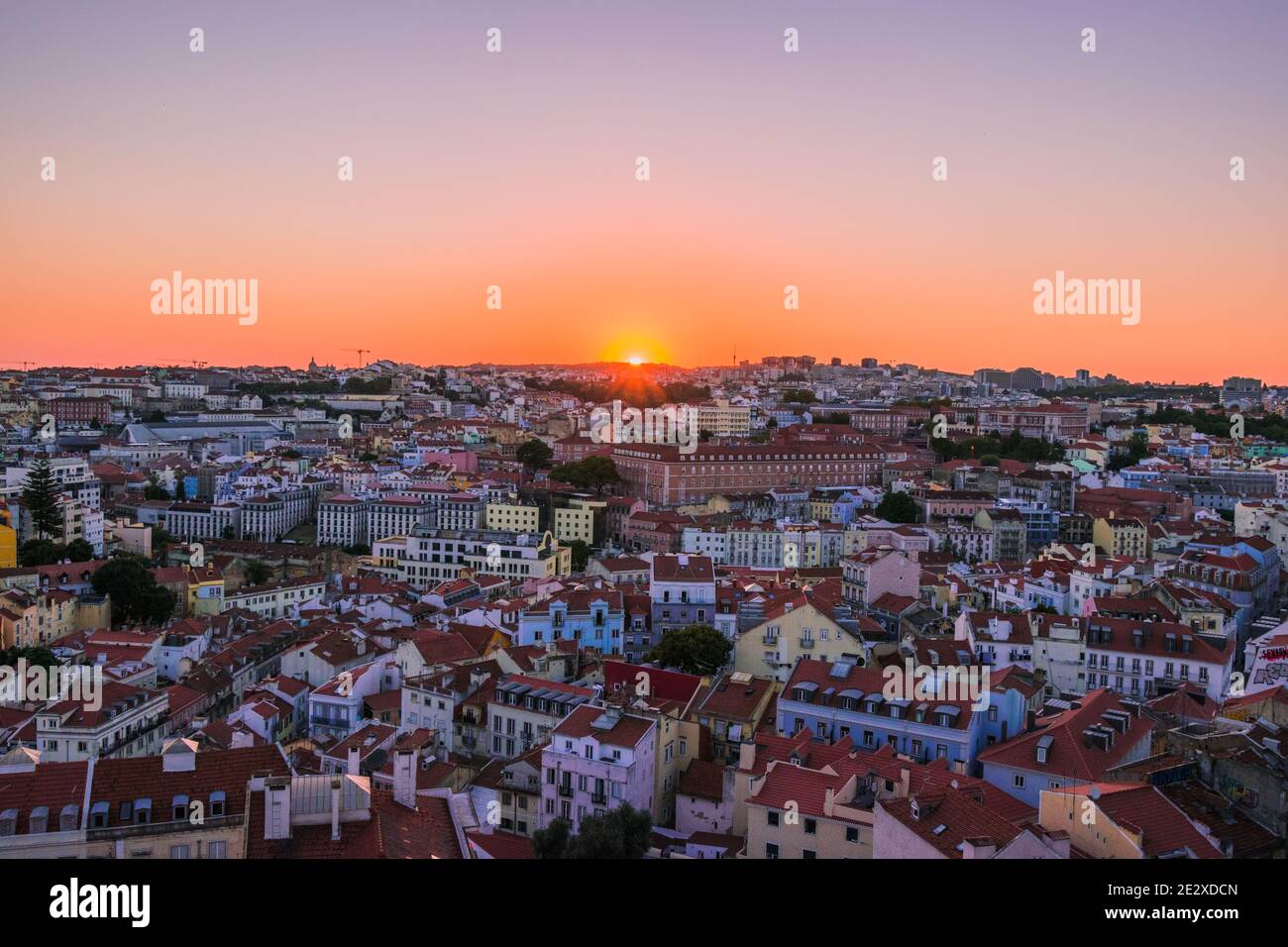 Sunset from Miradouro da Senhora do Monte, Lisbon, Portugal. A stunning view over the entire city and skyline, with a clear, cloudless sky. Stock Photo