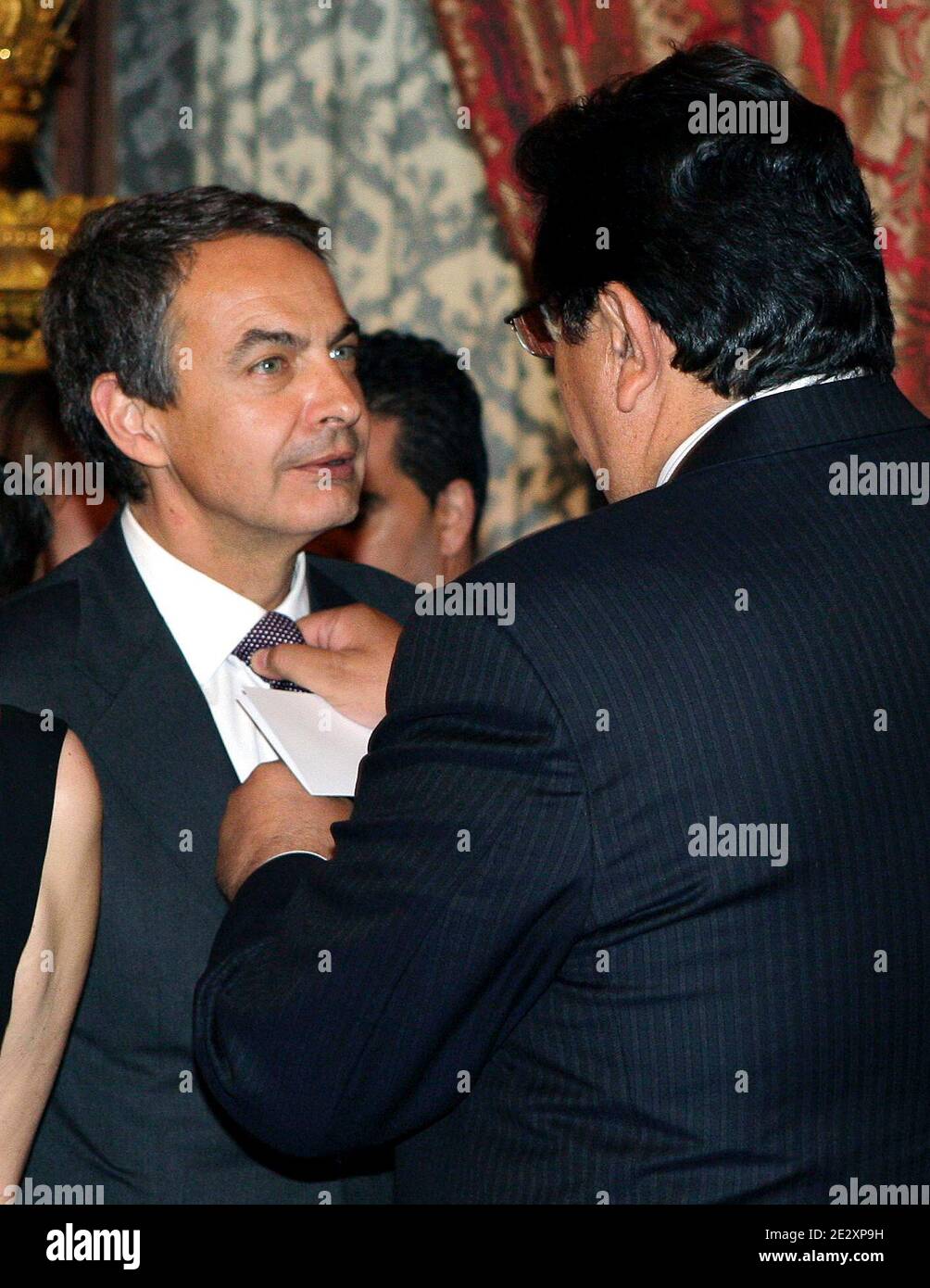 President of Peru, Alan Garcia (R) straightens up Spanish Prime Minister Jose Luis Rodriguez Zapatero's tie knot prior to the gala dinner for European Union and Latin America summit leaders at the Royal Palace in Madrid, Spain on May 17, 2010. This was the first time Prince Felipe replaced his father King Juan Carlos as host of an official dinner at the Royal Palace. The King is still convalescent of last week's operation. Photo by Almagro/ABACAPRESS.COM Stock Photo