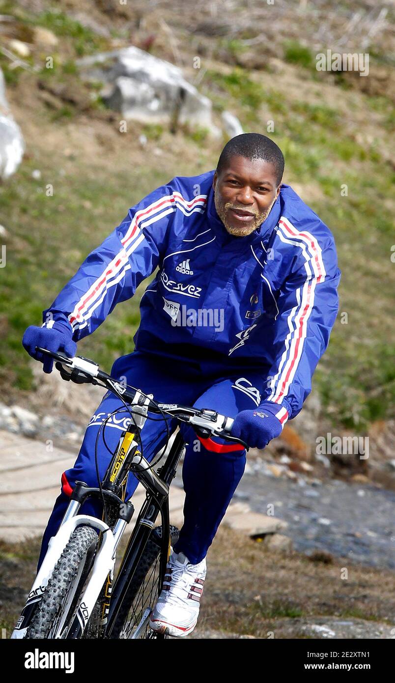 France national soccer team's player Djibril Cisse during a cycling  training session around a lake in Tignes, French Alps, France on May 19,  2010, as part of the preparation for the upcoming
