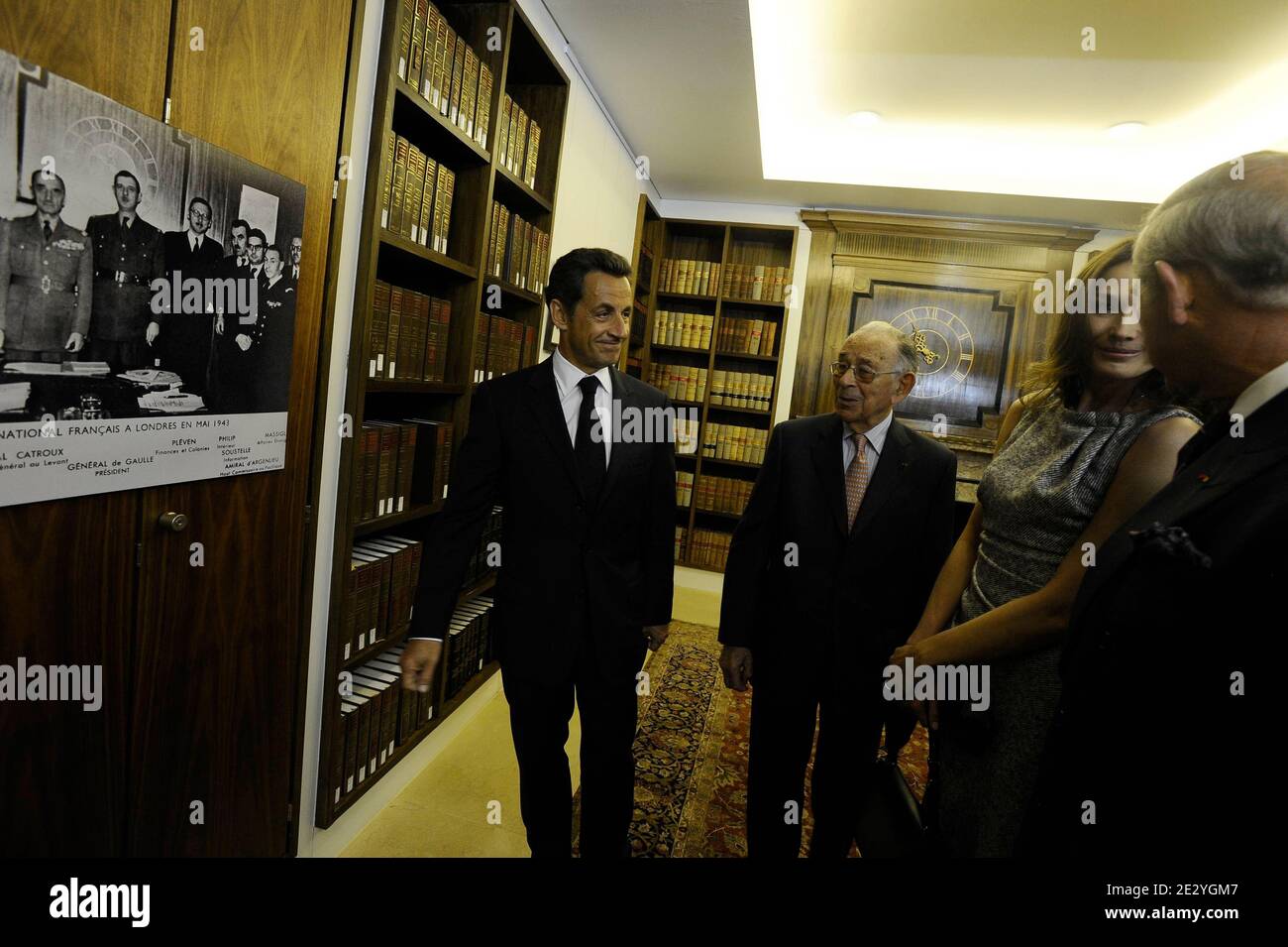 French President Nicolas Sarkozy, his wife Carla Bruni-Sarkozy and Prince Charles, Prince of Wales look at photographs of French President Charles De Gaulle during a visit to the former headquarters of the 'Free French', at Carlton Gardens in London, UK on June 18, 2010. Nicolas Sarkozy and World War II veterans visited London to mark the 70th anniversary of Charles de Gaulle's rousing radio appeal to his compatriots to resist the Nazi occupation. On June 18, 1940, four days after the fall of Paris and as the French government prepared to sign an armistice with Germany, the exiled military lea Stock Photo