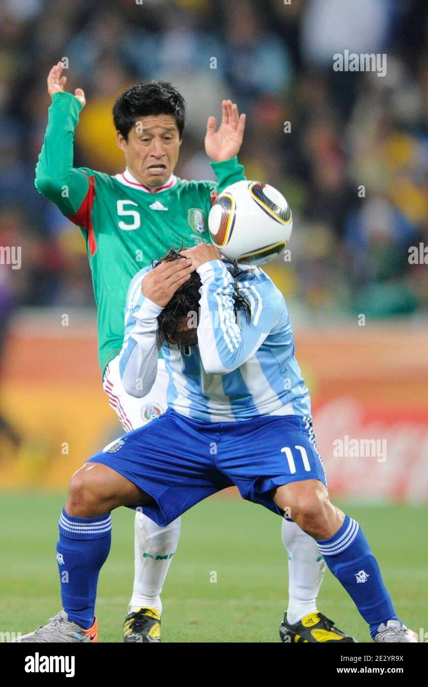 Argentina's Carlos Tevez battles Mexico's Ricardo Osorio during the 2010 FIFA World Cup South Africa 1/8 of final Soccer match, Argentina vs Mexico at Soccer City football stadium in Johannesburg, South Africa on June 27, 2010. Argentina won 3-1. Photo by Henri Szwarc/ABACAPRESS.COM Stock Photo